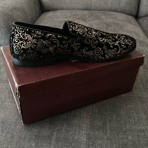 Black loafers with gold design